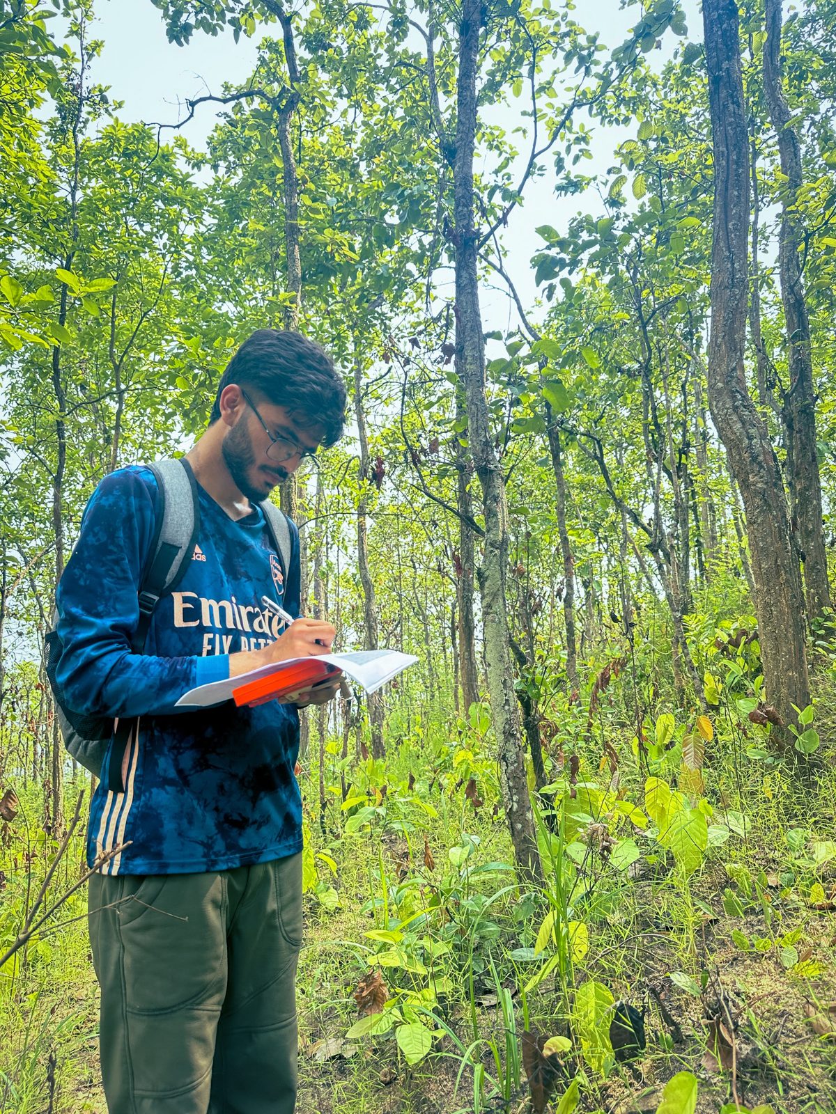 Kirtan Pandit writing field notes in a sal forest