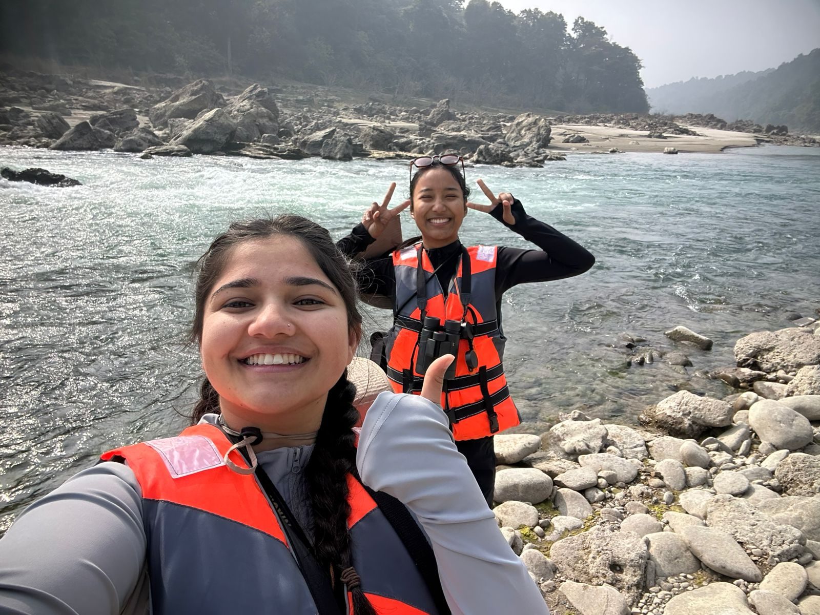 Abhishu Neupane and Shejal Pradhan in life jackets on a river bank