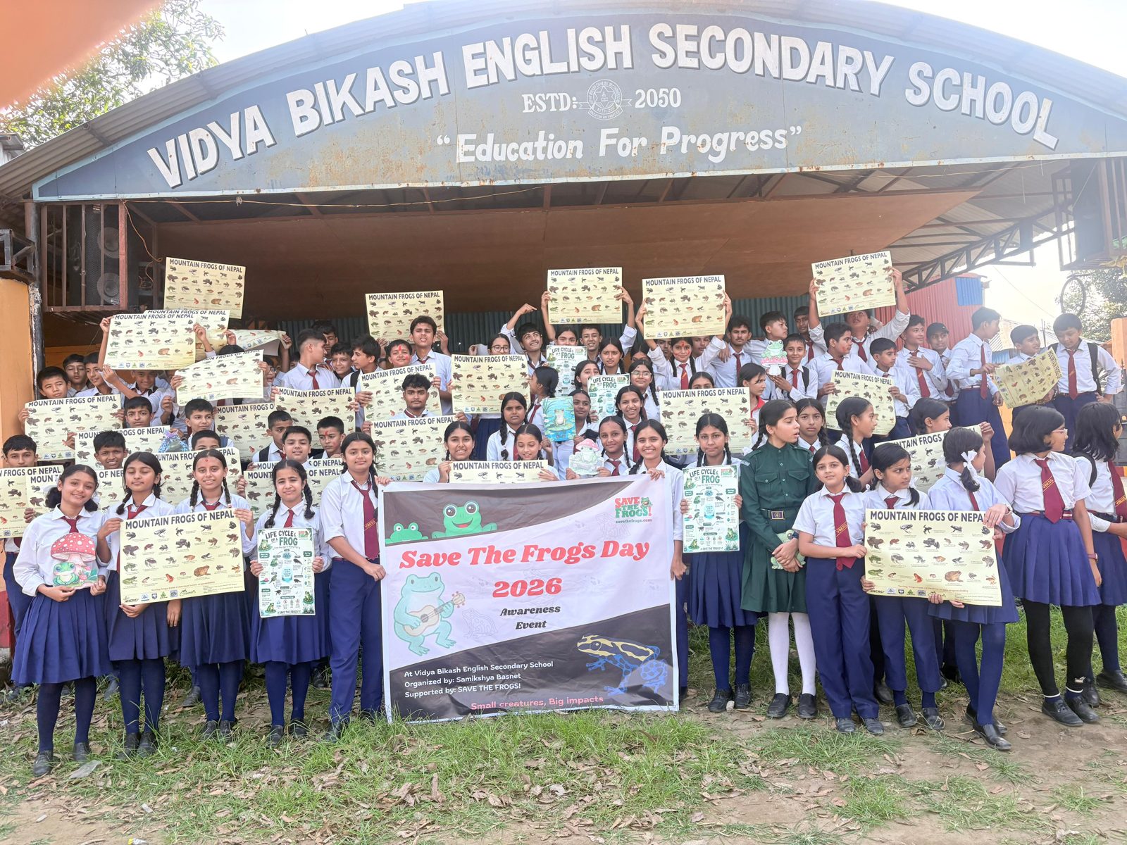 Samikshya Basnet with students of Vidya Bikash English Secondary School holding Mountain Frogs of Nepal posters